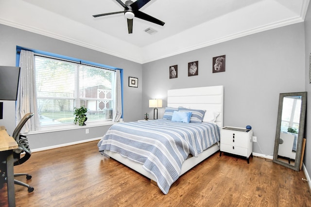 bedroom with hardwood / wood-style floors, ceiling fan, and ornamental molding