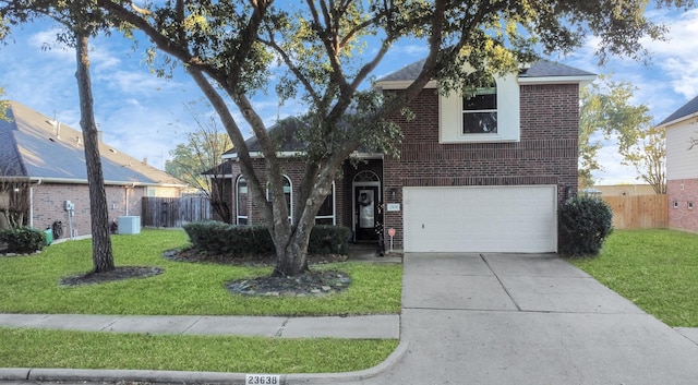 view of property with a front yard and a garage