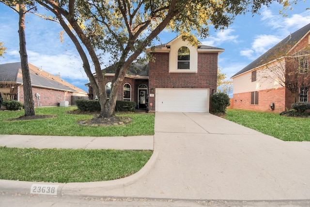 front of property featuring a front yard and a garage