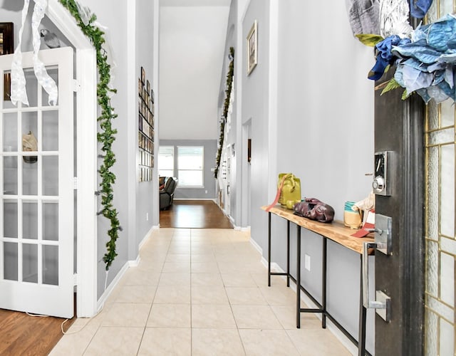 hall featuring light tile patterned floors