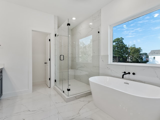 bathroom featuring vanity and shower with separate bathtub