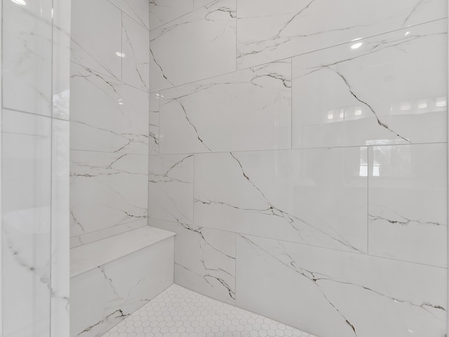 bathroom with a tile shower