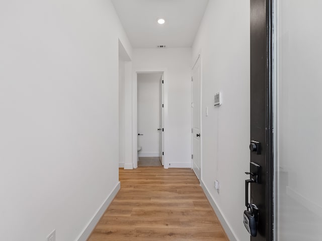 corridor with light wood-type flooring