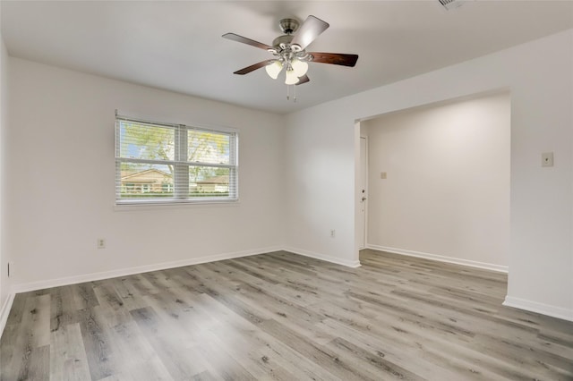 empty room with light hardwood / wood-style flooring and ceiling fan