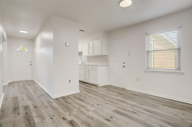 foyer entrance featuring sink and light hardwood / wood-style flooring