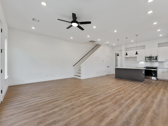 unfurnished living room with light hardwood / wood-style floors and ceiling fan