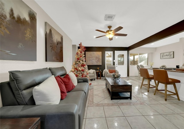 tiled living room featuring ceiling fan