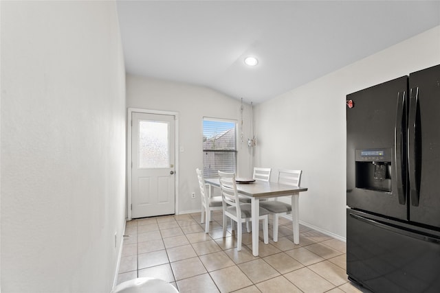 tiled dining room with lofted ceiling