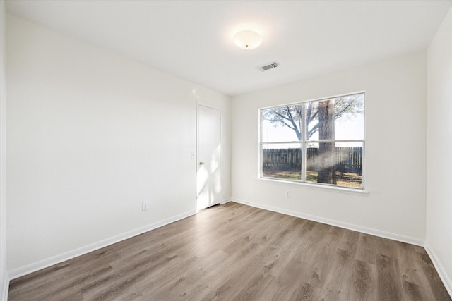 spare room featuring wood-type flooring