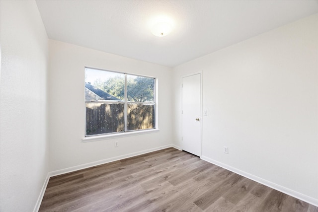 spare room featuring light wood-type flooring