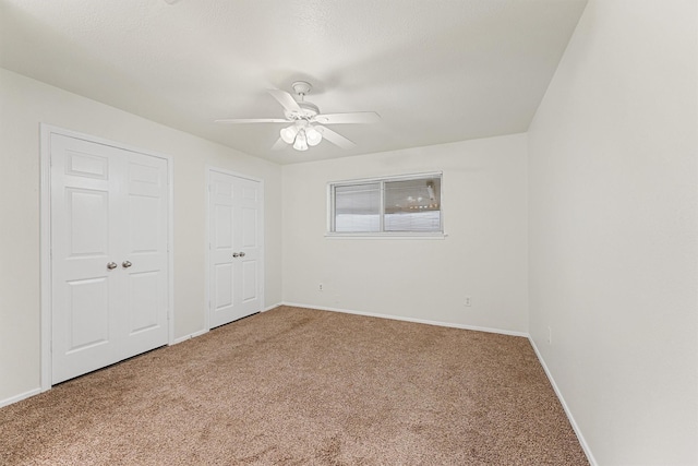 unfurnished bedroom with carpet floors and ceiling fan