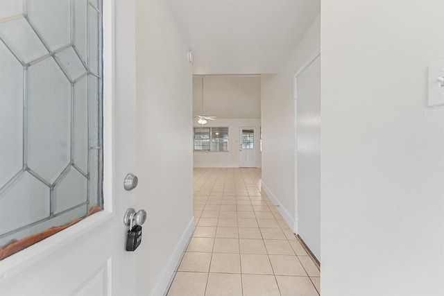 hall with light tile patterned floors