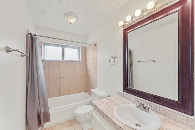 full bathroom with shower / tub combo with curtain, vanity, a textured ceiling, and toilet