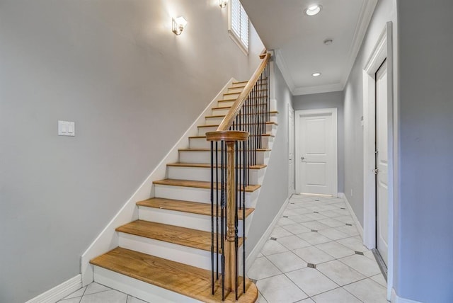 stairway with tile patterned flooring and ornamental molding