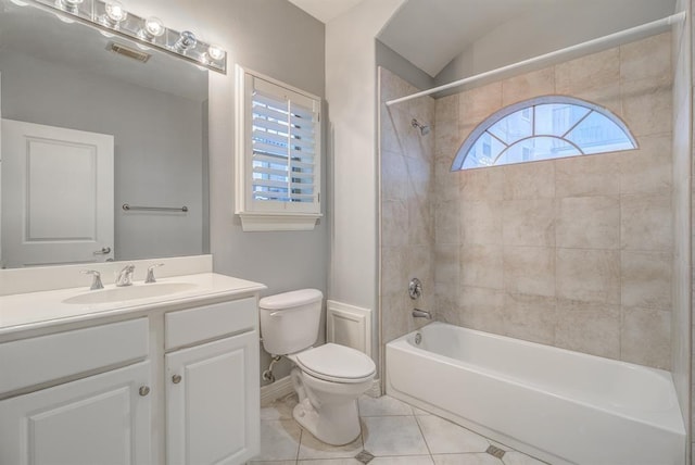 full bathroom with tile patterned flooring, vanity, tiled shower / bath combo, and toilet