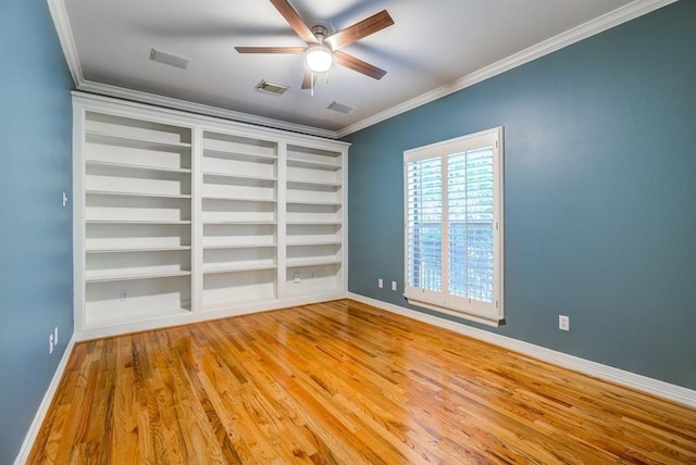 empty room with built in shelves, ceiling fan, ornamental molding, and light hardwood / wood-style flooring