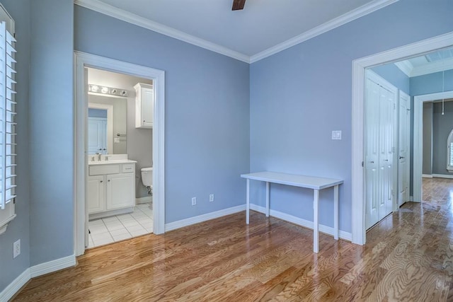 interior space with crown molding, light hardwood / wood-style flooring, ceiling fan, and sink