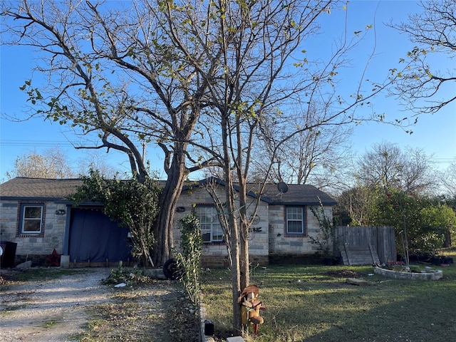 view of front of house with a garage and a front lawn