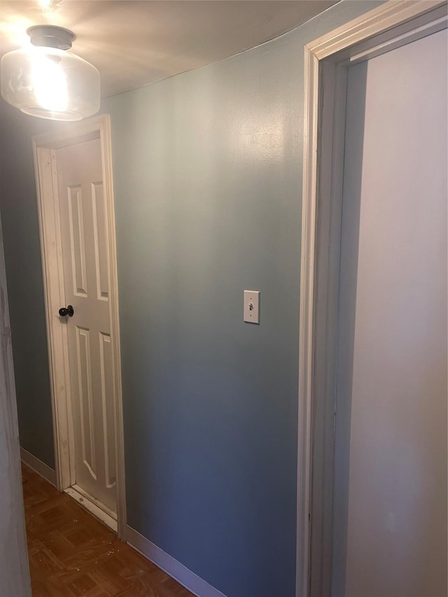 hallway with dark parquet floors