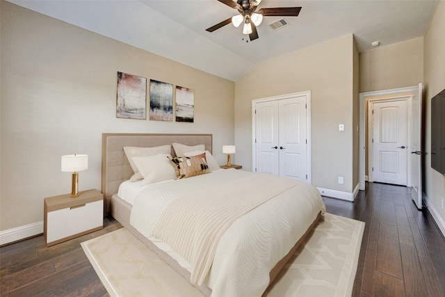 bedroom with ceiling fan, a closet, dark wood-type flooring, and lofted ceiling