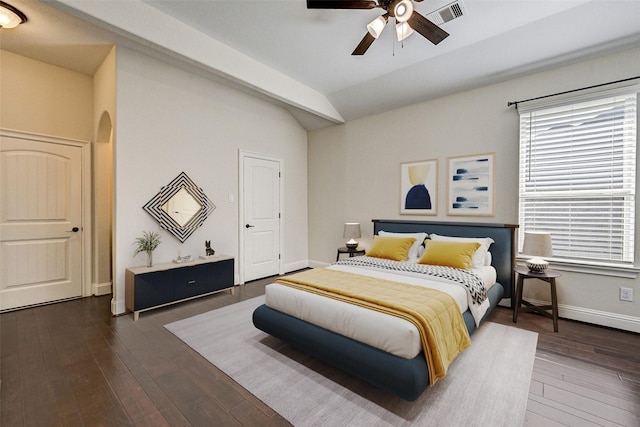 bedroom featuring dark hardwood / wood-style flooring, vaulted ceiling, and ceiling fan