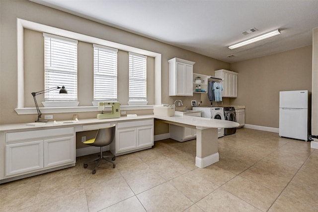 kitchen featuring washer and clothes dryer, white fridge, white cabinets, and light tile patterned floors