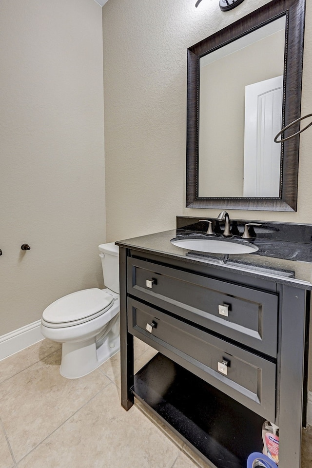 bathroom with tile patterned floors, vanity, and toilet