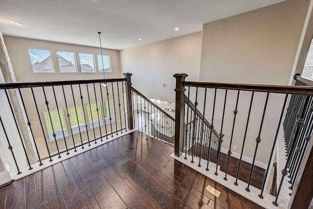 stairs with a healthy amount of sunlight and wood-type flooring