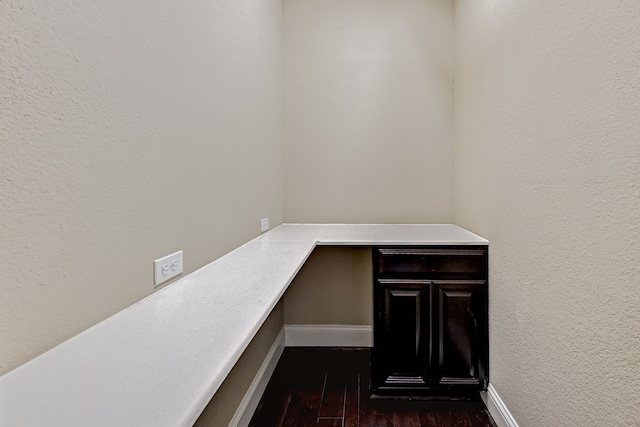 unfurnished office featuring dark hardwood / wood-style floors