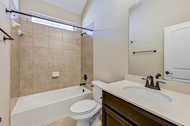 full bathroom with tile patterned flooring, vanity, tiled shower / bath combo, and toilet