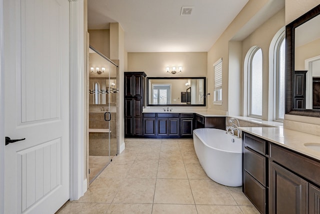 bathroom featuring tile patterned flooring, vanity, and separate shower and tub