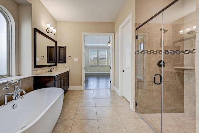 bathroom featuring vanity, ceiling fan, tile patterned flooring, and plus walk in shower