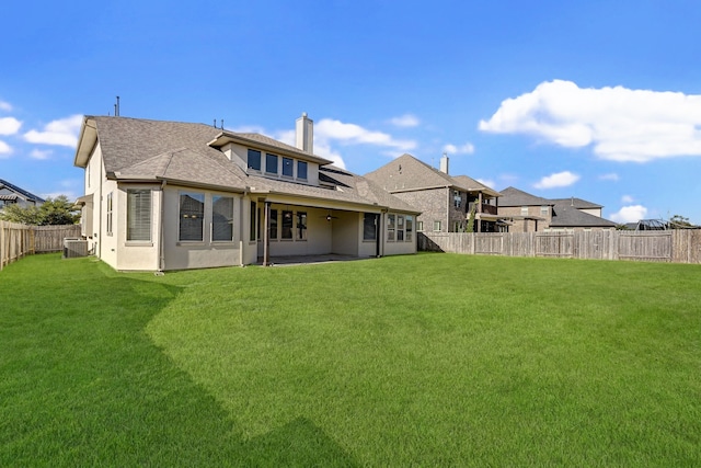 rear view of property featuring a lawn