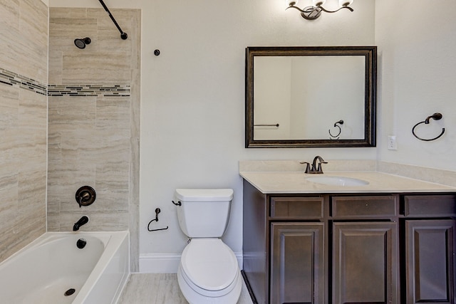 full bathroom with vanity, tiled shower / bath combo, and toilet