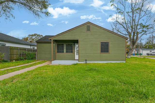 back of property featuring a lawn