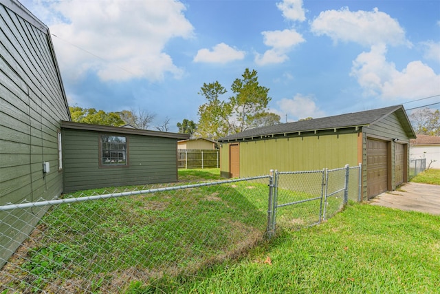 view of yard featuring an outbuilding and a garage