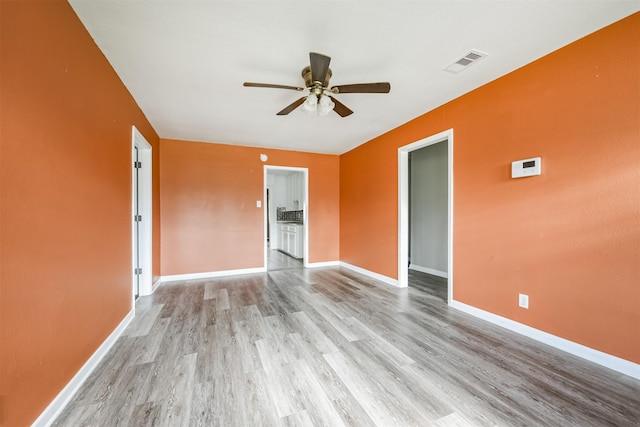 unfurnished room featuring light hardwood / wood-style flooring and ceiling fan