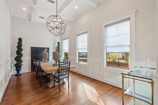 1148 Nicholson St, Houston, TX 77008 - dining area with coffered ceiling, a decorative wall, a chandelier, and beamed ceiling