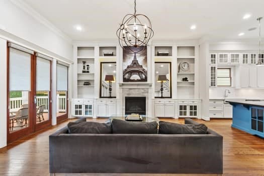 1148 Nicholson St, Houston, TX 77008 - living area featuring ornamental molding, a fireplace, wood finished floors, and a chandelier
