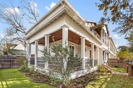 1148 Nicholson St, Houston, TX 77008 - view of home's exterior with fence, a balcony, stucco siding, a porch, and a yard