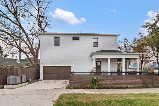 1148 Nicholson St, Houston, TX 77008 - view of front of property featuring fence, driveway, and a garage