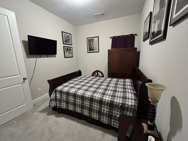 bedroom featuring light carpet