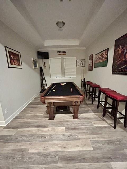 game room with hardwood / wood-style floors, billiards, ornamental molding, and a tray ceiling