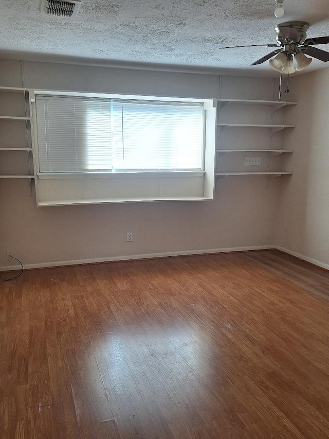 spare room featuring ceiling fan, a textured ceiling, and hardwood / wood-style flooring