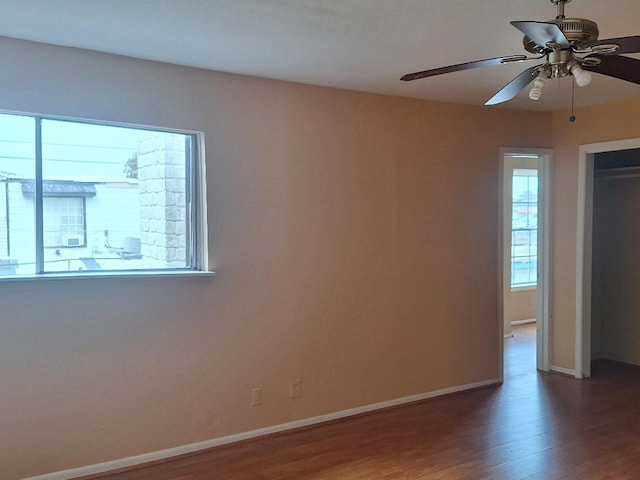 spare room featuring hardwood / wood-style floors and ceiling fan