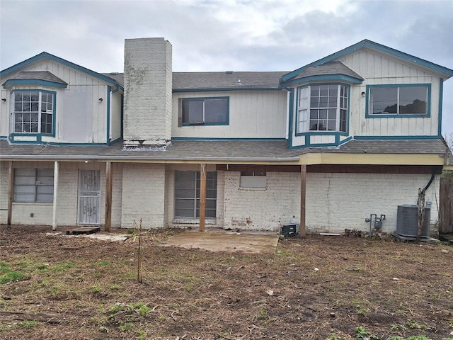 rear view of house featuring cooling unit