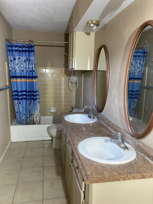 full bathroom featuring tile patterned flooring, a textured ceiling, toilet, and shower / bath combo with shower curtain