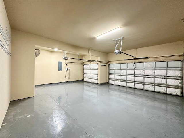 garage with electric panel and a garage door opener