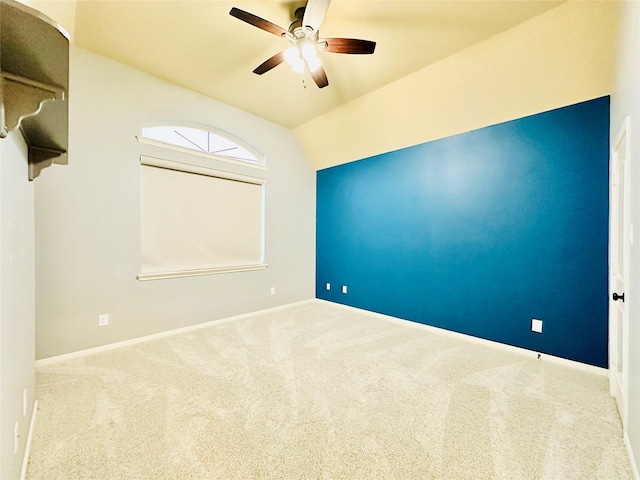 empty room with carpet, ceiling fan, and vaulted ceiling