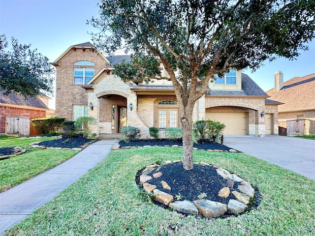 view of front of property featuring a front lawn and a garage